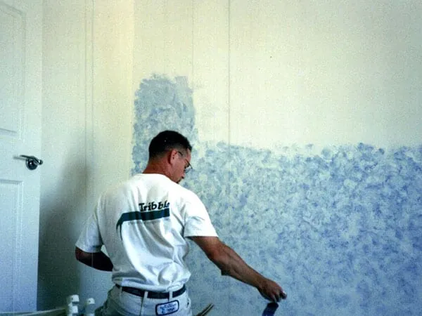 Todd Tribble painting a wall back in his painter days