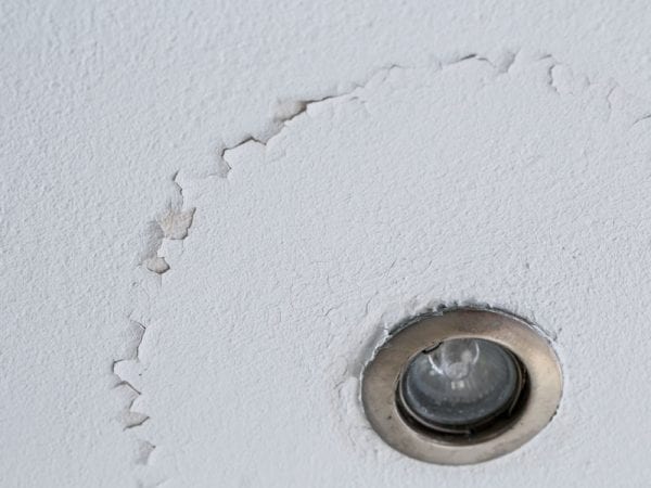 Peeling ceiling paint in need of painting