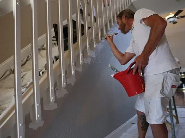 Three man painting team painting an interior