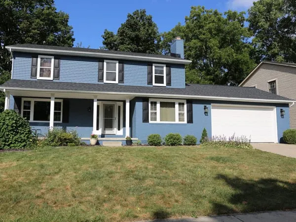 Freshly painted aluminum siding and brick house