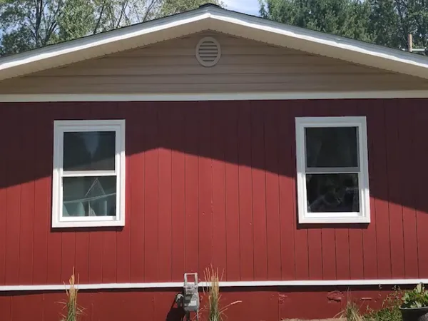 House with red T1-11 siding