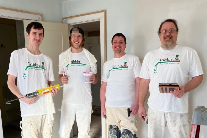 Four professional painters from the Tribble Painting Company on a work site
