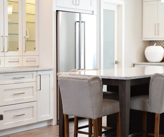 Freshly painted white cabinetry with glass doors and new fixtures